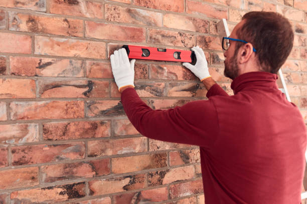 istock Handyman with spirit level working in a new home interior. 2150678652