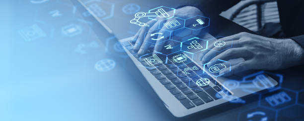 istock Man using laptop virtual screen with factory controls and robot industry 2150679132