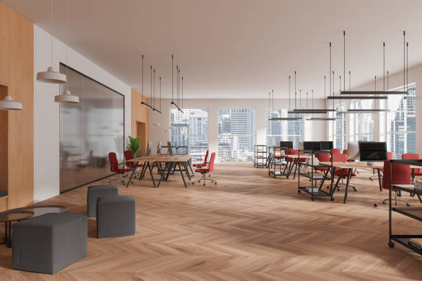 istock Stylish coworking interior with desk and pc computers, panoramic window 2150679310