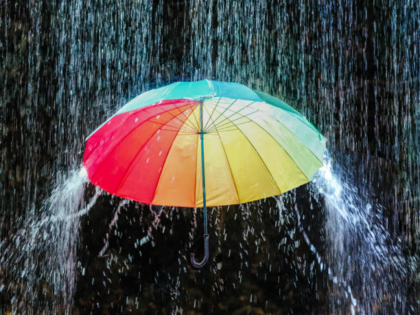 istock Colorful umbrella in the pouring rain 2150679540