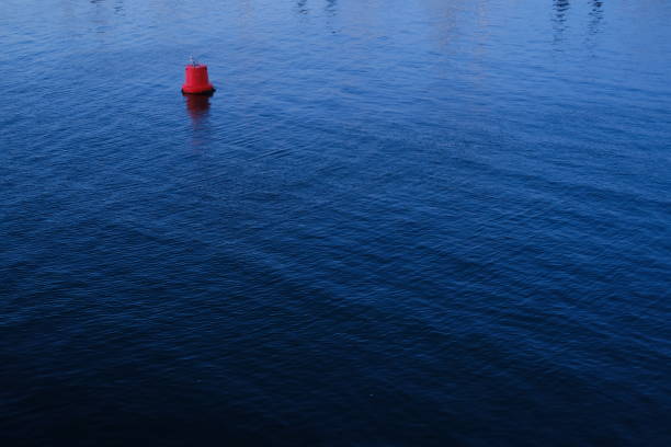 istock A red buoy isolated floating on the blue water. 2150680385