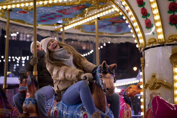 istock Couple having fun on the carousel 2150680402