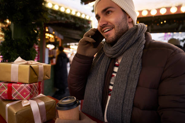 istock Man calling via phone on Christmas Market 2150680486