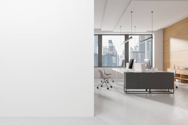 istock White coworking interior with desk and pc monitors, window. Mockup wall 2150680715