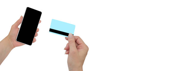 istock A woman holds a credit card in her hand and enters a security code using her mobile phone. black friday sale. Banner. 2150682157