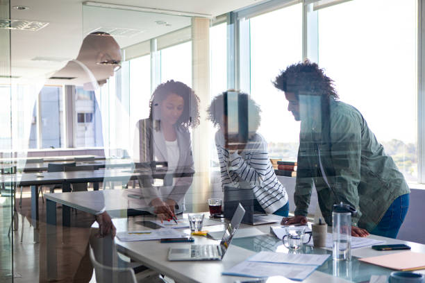 istock Small diverse group of coworkers brainstorming while working on marketing project 2150685414