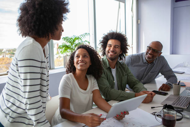 istock Small diverse group of coworkers collaborating on project inside meeting room 2150685512