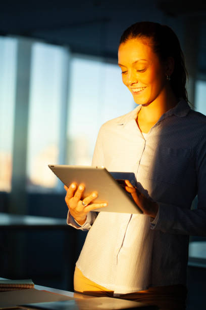 istock Young woman checking messages on digital tablet 2150686558