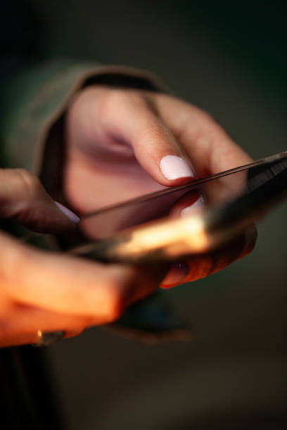 Unrecognizable person's hands using cell phone