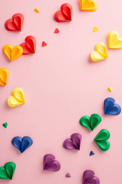 istock Brightly vertical colored paper crafted hearts arranged artistically on a pink background symbolizing love and diversity for Pride Month 2150688883