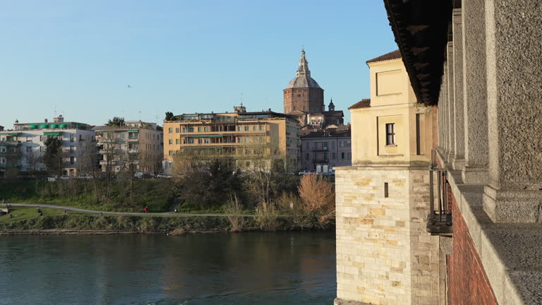 Nice view of Ponte Coperto (covered bridge) and Background the Duomo di Pavia (Pavia Cathedral) in Pavia ,clear sky, Lombardy, italy.