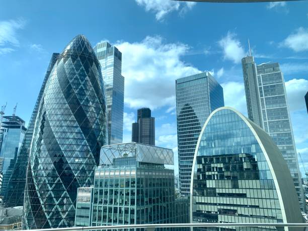 Daytime view of famous buildings in London Shiny glass buildings on blue cloud day in London london england stock pictures, royalty-free photos & images