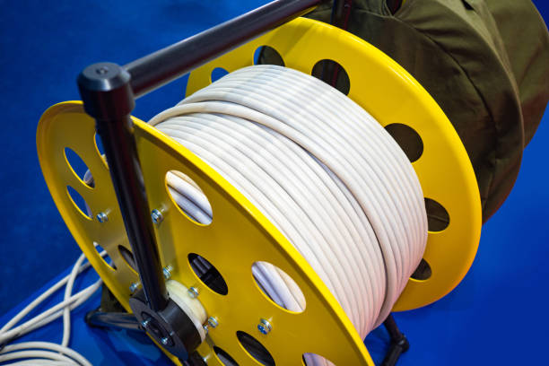 istock Extension cord. Power extension cord on the reel. The wire is wound on a spool. Electrical cable. Large electric extension cord. Repairs. Equipment for construction. Sale of electrical equipment 2150691085
