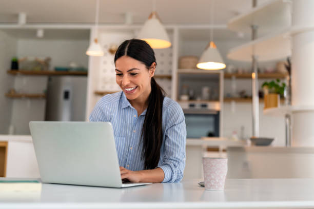 istock Happy young woman freelancer working on computer, studying online, shopping in internet store. 2150692355