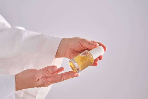 istock Blue serum with pipette in a womans hands in a robe. 2150693411