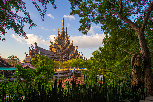 Temple of Truth against the lush vegetation of Thailand. Business card of Thailand. Buddhism. Big wooden Church. The Nature Of Thailand. Religious building. The sharp spires of the Temple of truth.