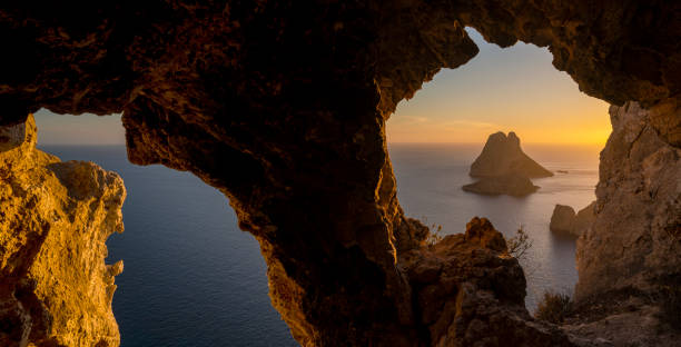 istock Es Vedra sunset view from a hole of a cave 2150694439