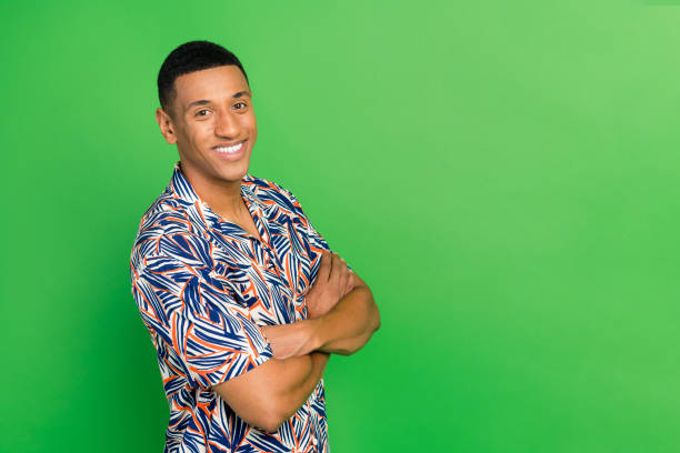 Profile portrait of positive young person beaming smile folded hands empty space isolated on green color background.