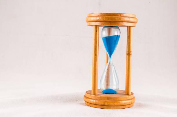 istock A wooden clock with a blue face and hands 2150696026