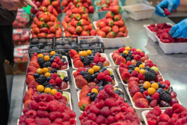 August 10, 2023-Vancouver, BC, Canada-Close up of boxes of colorful fresh organic berries on display at a farmers market.