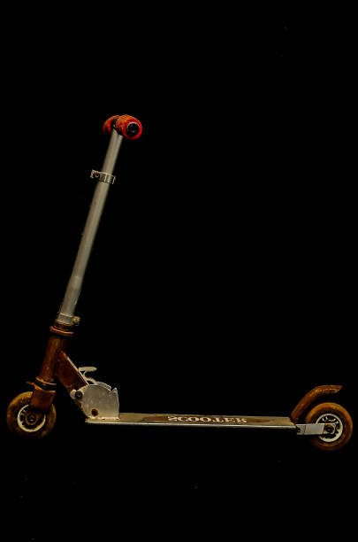 A scooter with the word Head on it. The scooter is leaning on a black background