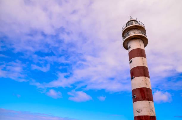 istock A lighthouse is standing tall in the sky with a blue sky in the background 2150697316