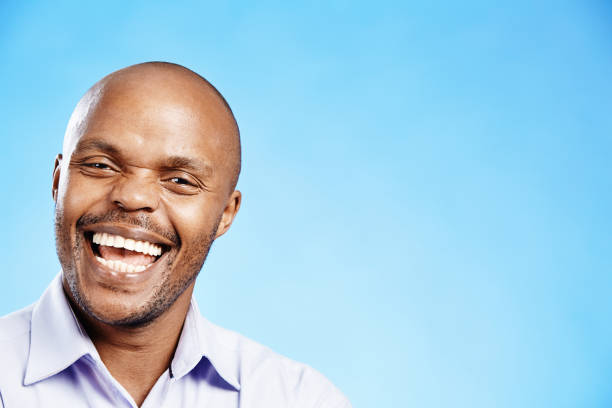 istock Happy man smiles and laughs as he looks at the camera 2150697406