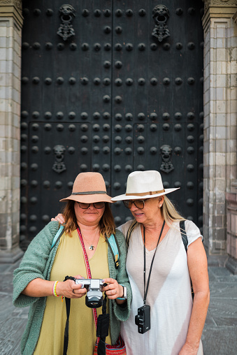 Two European tourists reviewing photos from their trip to Peru.