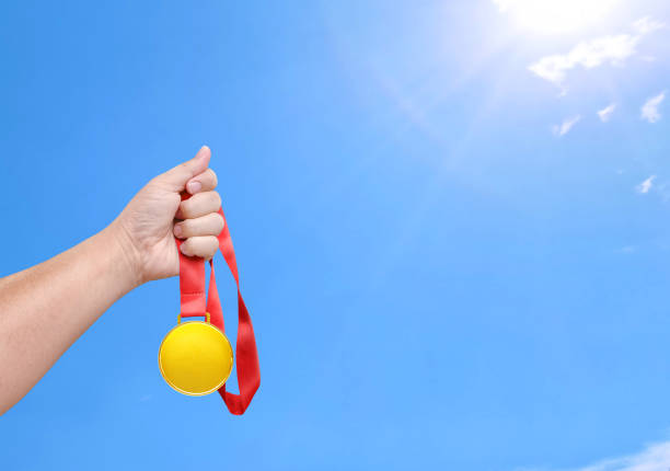 Holding a gold medal, winner, sky background