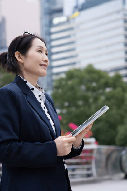 istock Professional Businesswoman Using Tablet in Cityscape 2150697986