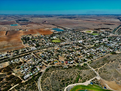 Arial views of a small country town with a very blue lake in the mallee region of rural Australia