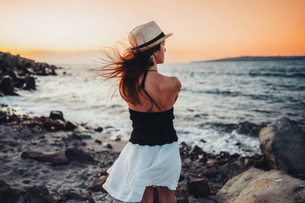 Girl in melancholy mood standing at the beach