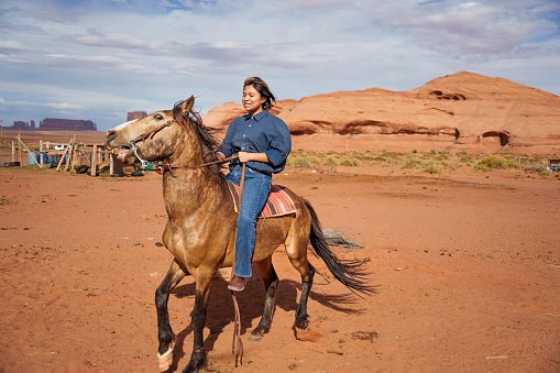 Sixteen Year Old Navajo Girl Video Portrait as She Sits on Her Horse Near a Corral on a Ranch in Monument Valley Arizona Under Pretty Skies