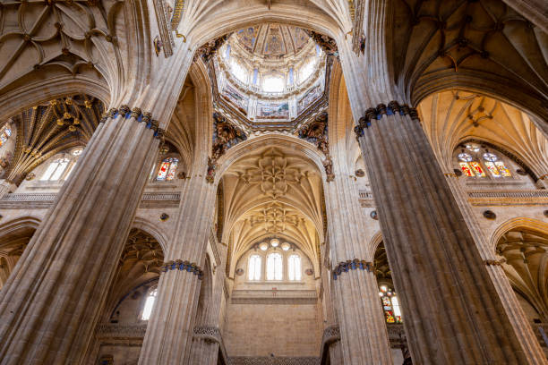Salamanca, Spain, 06.10.21. Richly decotated New Cathedral (Catedral Nueva) in Salamanca, inside view with decorative stone vaults, columns and stained glass windows and baroque dome.