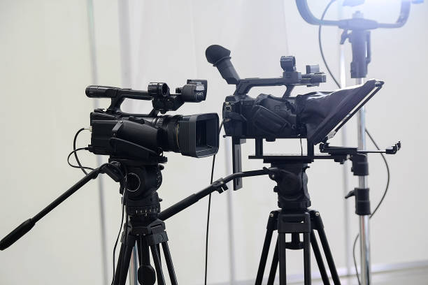 istock Video cameras on tripods and studio lights pavilion. Industry 2150702841
