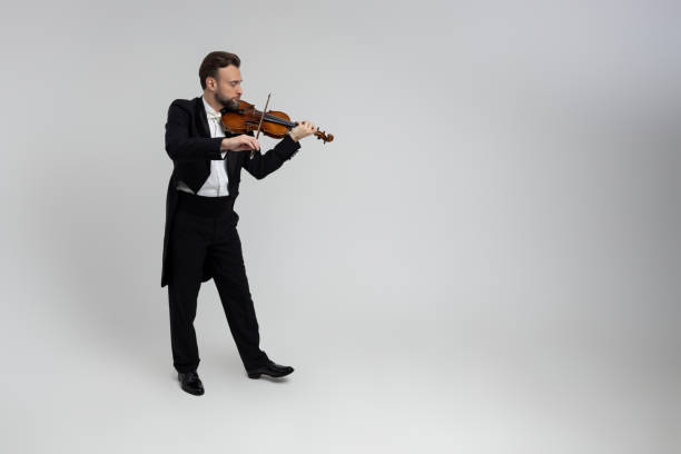 istock Handsome man artist playing violin 2150704793