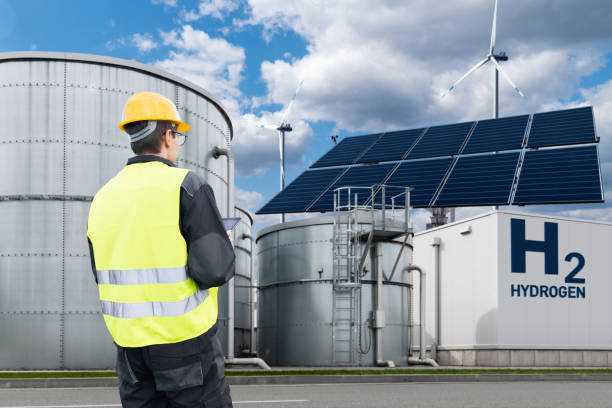 istock Engineer with tablet computer on a background of Green Hydrogen factory. 2150704952