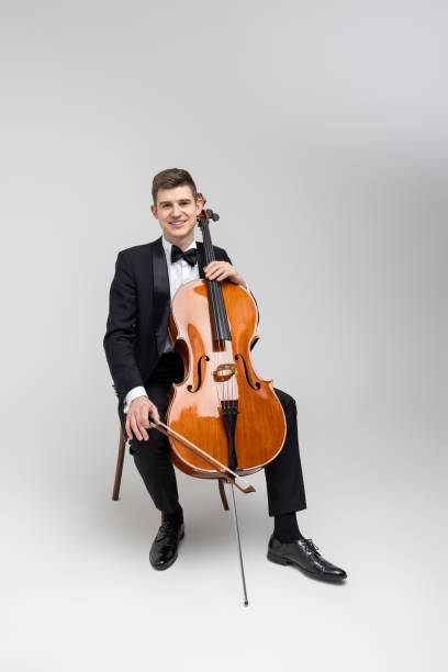 istock Passionate cello player sitting on chair performing concert 2150704977