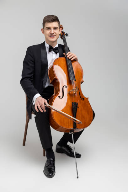 istock Passionate cello player sitting on chair performing concert 2150704989