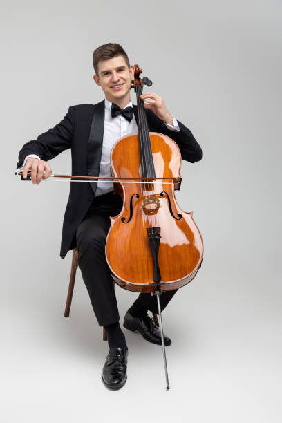 istock Passionate cello player sitting on chair performing concert 2150704990