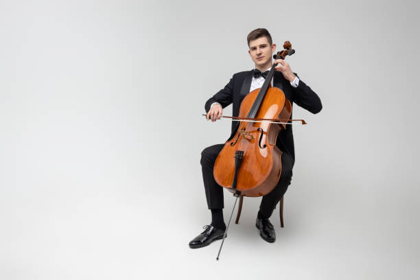 istock Passionate cello player sitting on chair performing concert 2150704991