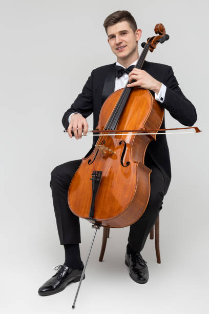 istock Musician sitting on chair playing cello 2150705000