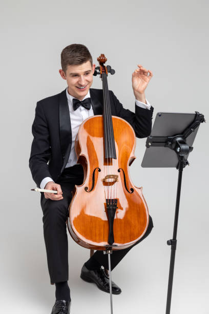 istock Man musician performing with cello and music note 2150705048