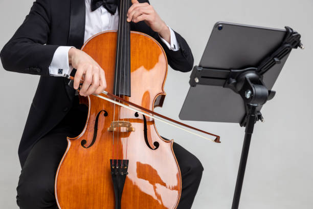 istock Unrecognizable man artist wearing tuxedo playing cello with music note 2150705052