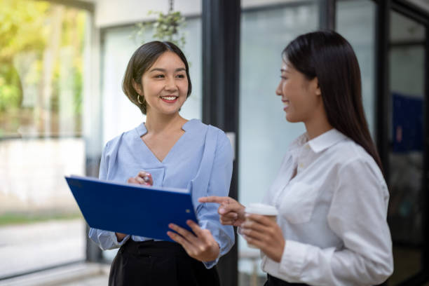 istock Two business colleagues chatting, sharing ideas 2150705504