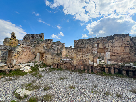 Clouds drift over the crumbled walls of the ancient baths in Afrodisias, as history lies etched into the very stones and arches that witnessed centuries unfold.