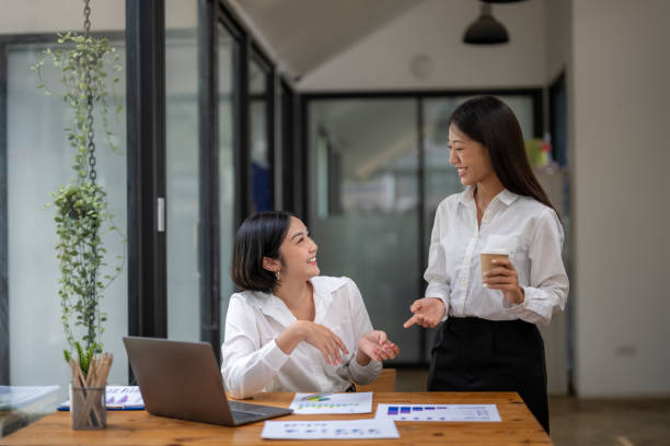 istock Two business colleagues talking share ideas 2150705730