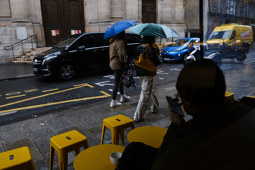 A man enjoy a coffee during a rainy day  in Paris, France, March 30,, 2024.