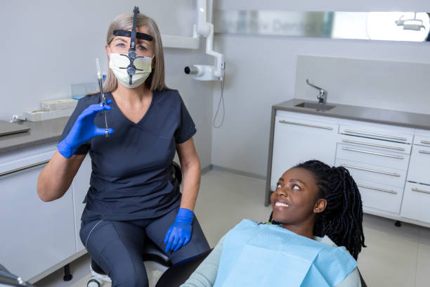 istock Female dentist making an anesthetic injection before tooth treatment 2150708011