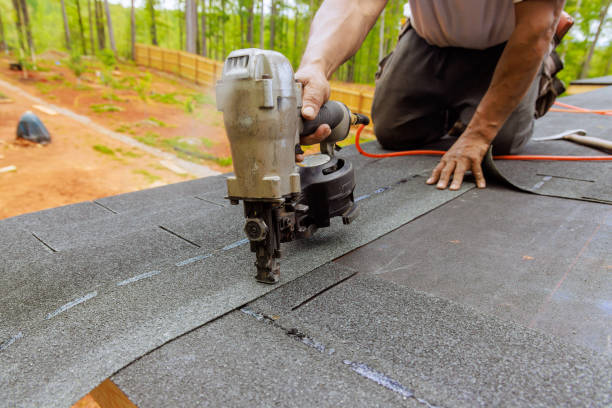 istock Using an air pneumatic nail gun, a roofer install new asphalt bitumen shingles 2150714742